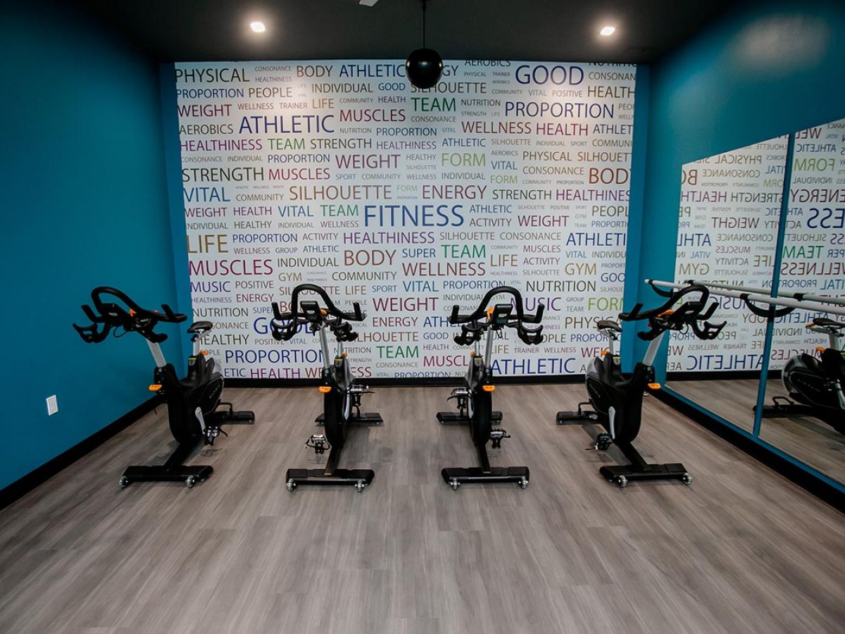 Westrum Corporate Stationary bikes, teal walls, and motivational quotes create an energizing gym space at Hub at 31 Brewerytown Philadelphia apartments.