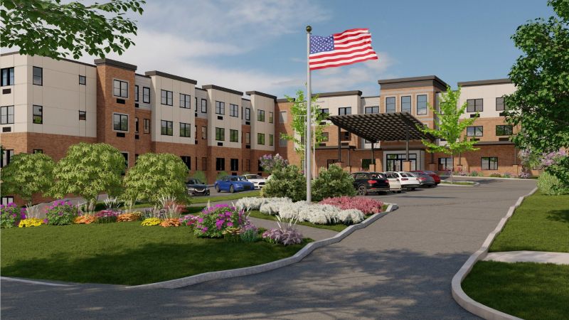 Westrum Corporate Aviv at Radnor is a modern three-story building with cars, an American flag, and landscaped gardens welcoming you along the entry path.