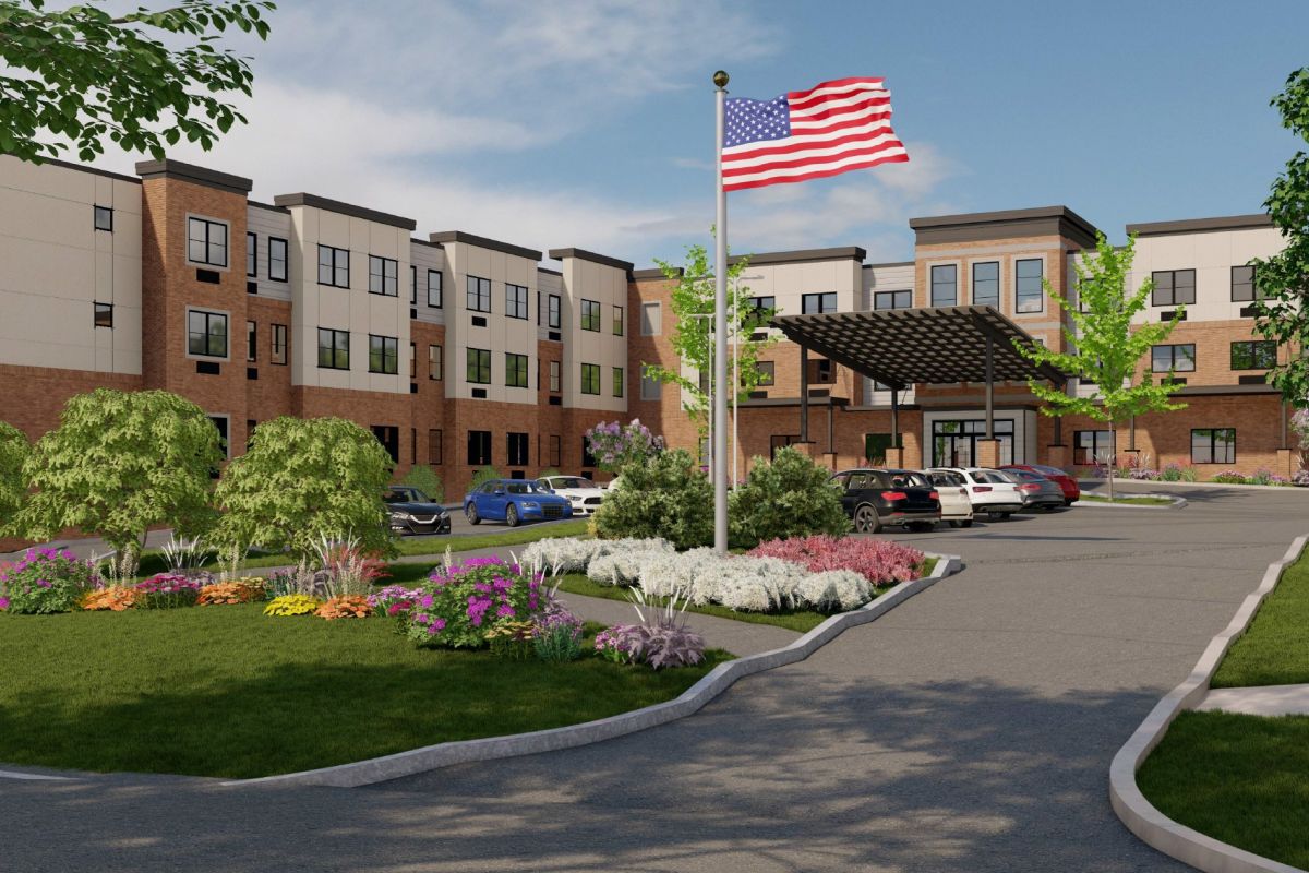 Westrum Corporate Aviv at Radnor is a modern three-story building with cars, an American flag, and landscaped gardens welcoming you along the entry path.