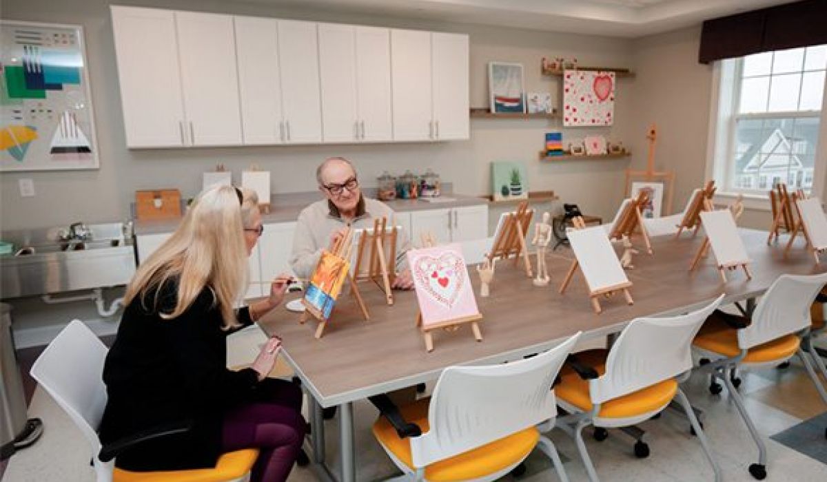 Westrum Corporate Two older adults paint at easels in a bright art room at Pointe@31 Brewerytown, reflecting community excellence and creativity.