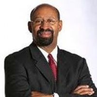Westrum Corporate Michael Nutter stands in a black suit, red tie, and glasses, arms crossed confidently against a white background.