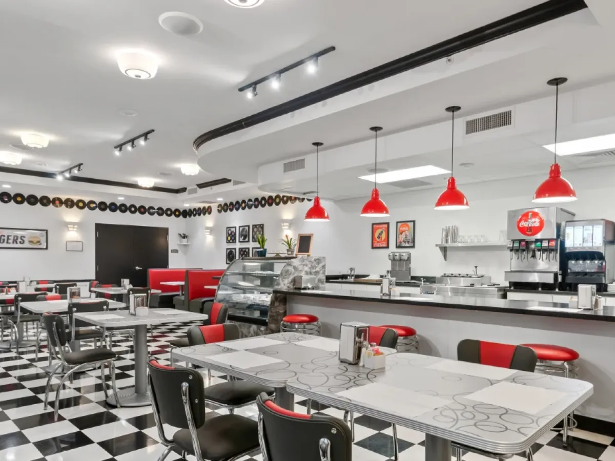 Westrum Corporate Retro diner in West Chester with black-and-white checkered floor, red stools, vintage decor, and a classic vibe at Arbour Square.