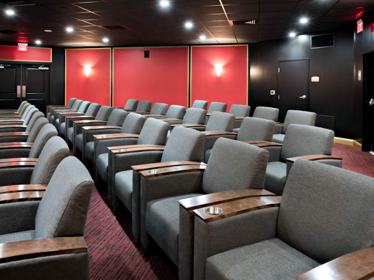 Westrum Corporate Rows of gray theater seats fill this modern cinema at Arbour Square, a premier senior living community in West Chester.