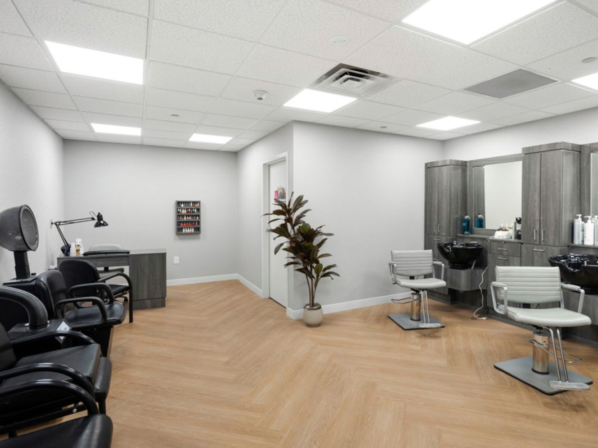 Westrum Corporate Modern salon at Arbour Square, Harleysville, with styling chairs, wash stations, mirrors, and products—perfect for senior living.