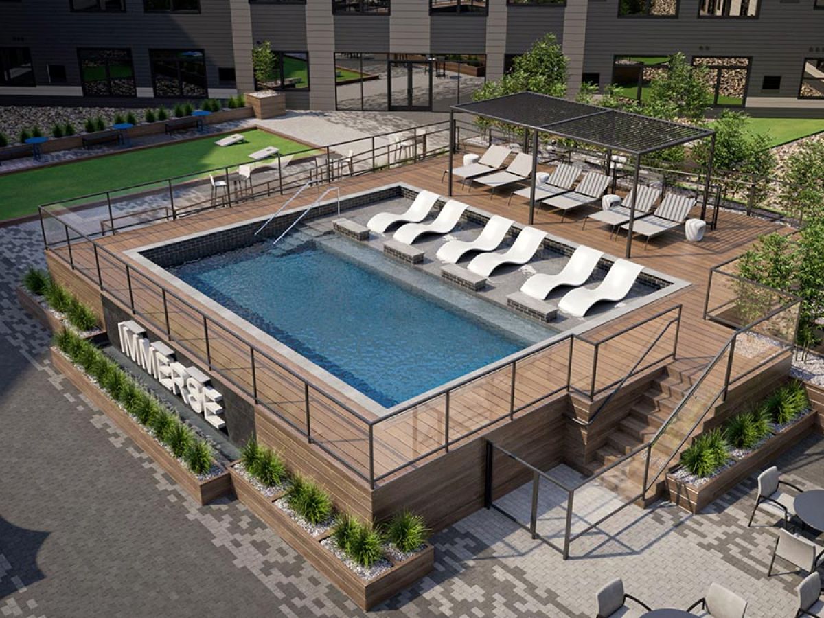 Westrum Corporate Modern rooftop pool at Luxor with lounge chairs, shaded seating, and greenery on a wood deck, overlooking Fort Washington courtyard.